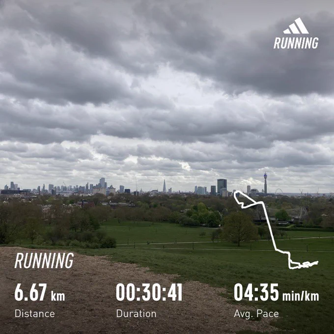 View over London skyline on a grey day from a hilly park; running stats superimposed (6.67km, 30:41)