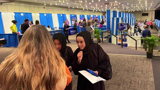 Two job seekers discuss career opportunities with an OG team member during the Dr. King Career Fair at the Empire State Plaza Convention Center.