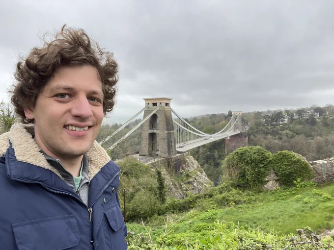 Me standing in front of a suspension bridge.