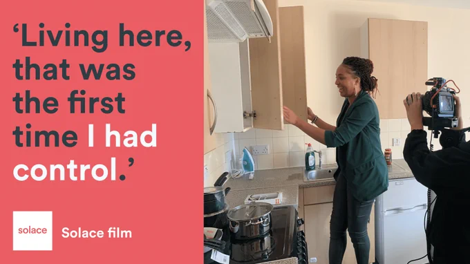 Image Description: Woman showing her kitchen living space. Text reads 'Living here, that was the first time I had control'