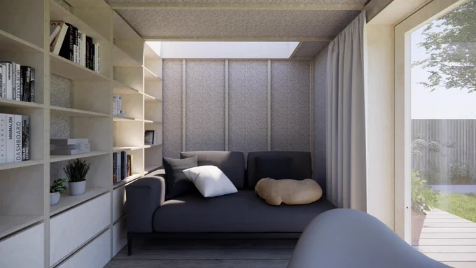 Inside of a garden office. Under the skylight one can see shelving and a sofa.