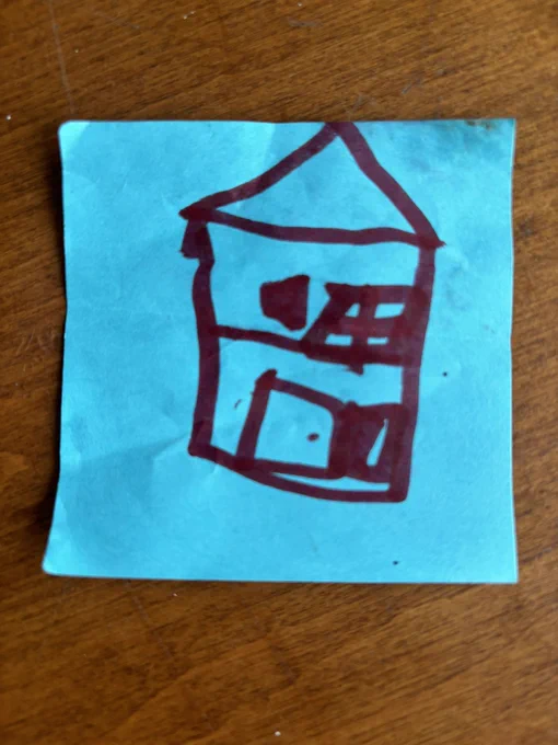 A blue post-it note with a drawing of a house in red marker