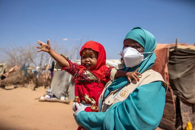 Save the Children’s Family Health Worker Muna (42) holds Suhuur (2), who she diagnosed and treated for pneumonia