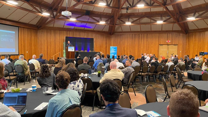 Pictured: Jason Busch addresses the audience at OREC '23. OREC MECC 2024 returns to Portland's West Hills and the World Forestry Center. Photo by Aaron Franco / POET