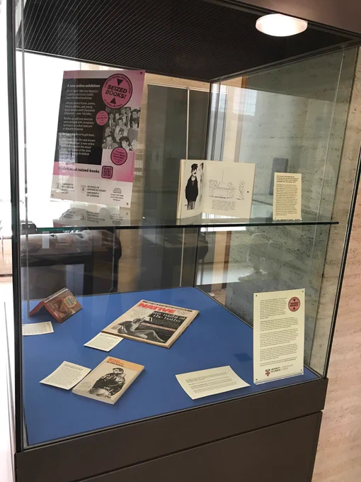 Display case showing New York Native newspaper, a Phil Andros novel with Tom of Finland cover and exhibition info
