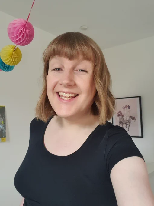 beth smiling at the camera wearing a black top