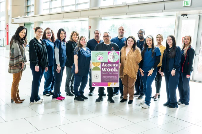 Group of people holding a poster that says Patient Access Week
