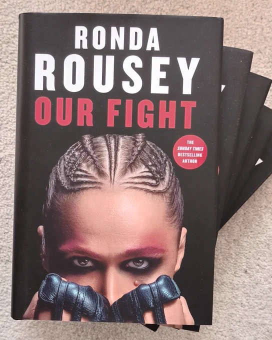Cover of Ronda Rousey's new memoir, Our Fight. It shows Ronda staring over a pair of gloved fists. 