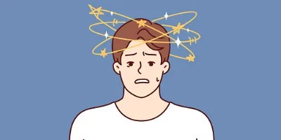 A distressed-looking young man in a white shirt is shown over a blue background. Swirls of stars and bright diamonds are above his head, indicating an injury.