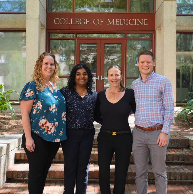 The fellowship team poses for a group photo in front of the UF College of Medicine.