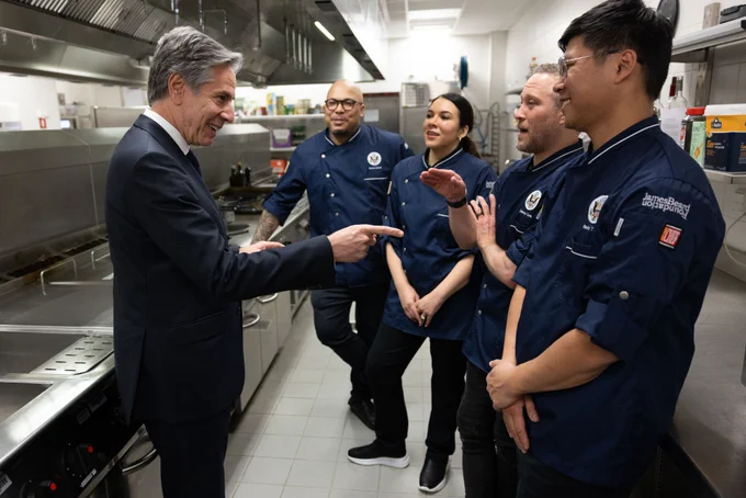Secretary Blinken interacts with chefs who are part of the American Culinary Corps at the Taste of D.C. reception in Brussels, Belgium. The chefs, from left, are Jerome Grant, Daniella Senior,  Johnny Spero, and Kevin Tien. (Official State Department photo by Chuck Kennedy)