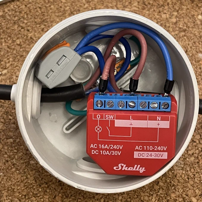Shelly 1 PM wired inside an electrical junction box with male/female shucko plug