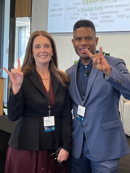 Claudia Lucchinetti and Craig Watkins make the Hook 'em, Horns hand signal.