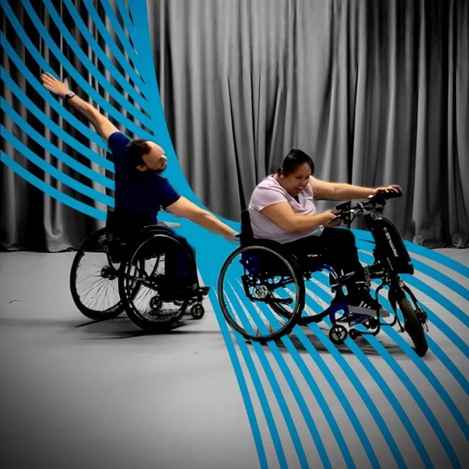 Two artists in wheelchairs dancing