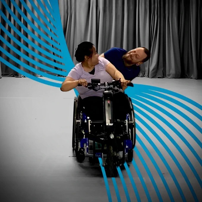 Two artists in wheelchairs dancing