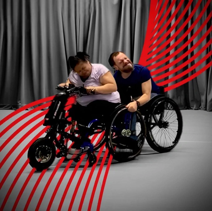Two artists in wheelchairs dancing