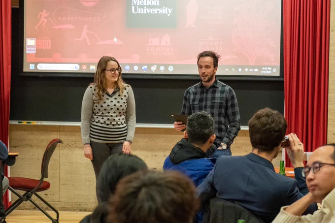 A student receives an award from her advisor.