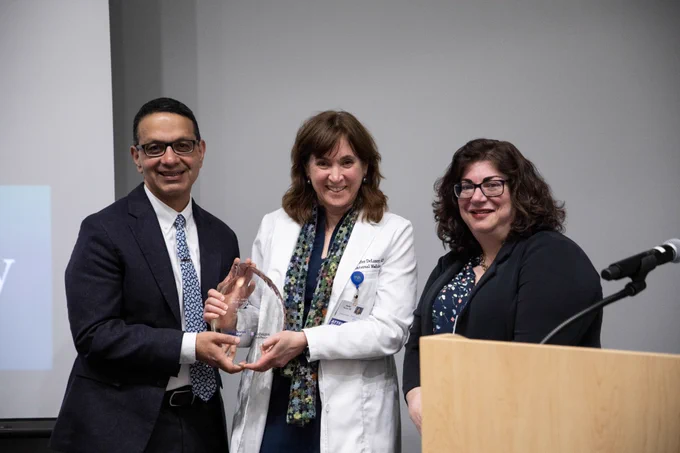 Sanjeev Bhalla, MD, Jennifer DeLaney, MD, and Pamela Woodard, MD, pose for a photo while holding the glass plaque presented to Dr. Bhalla in commemoration of the Neville Grant Award.