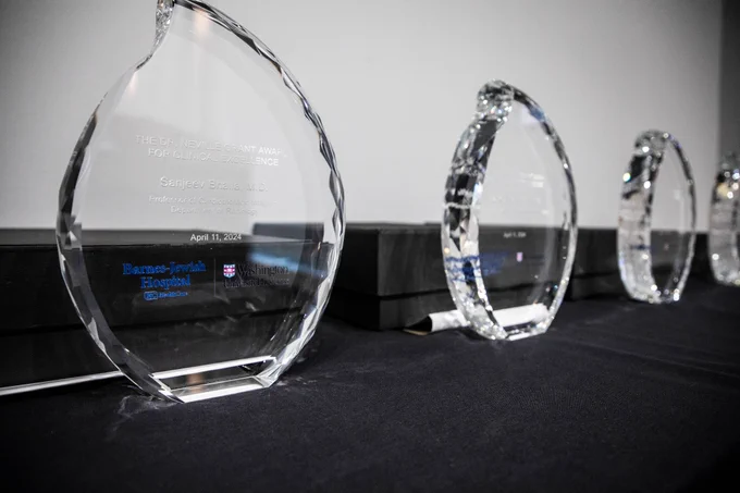 A commemorative glass plaque that reads:
The Dr. Neville Grant Award for Clinical Excellence

Sanjeev Bhalla, MD