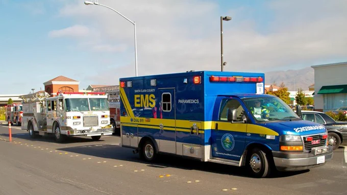a picture of an ambulance and firetruck driving down the road