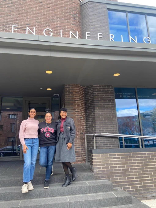 Hita, Ro, and Princess standing on the steps of Levine Hall.
