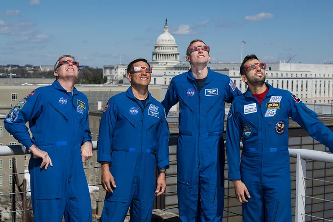 NASA astronauts Stephen Bowen, left, Frank Rubio, Warren Hoburg, and UAE (United Arab Emirates) astronaut Sultan Alneyadi, right, pose for a photo wearing solar glasses at the Mary W. Jackson NASA Headquarters building in Washington. Credit: (NASA/Aubrey Gemignani)
