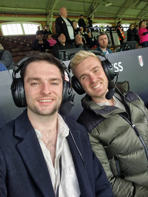 Selfie photo of Sam and Nick (left to right) in their commentary position ready for kickoff!