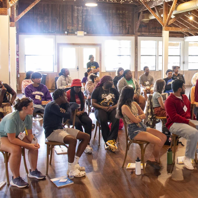 students sit together and listen to a presentation