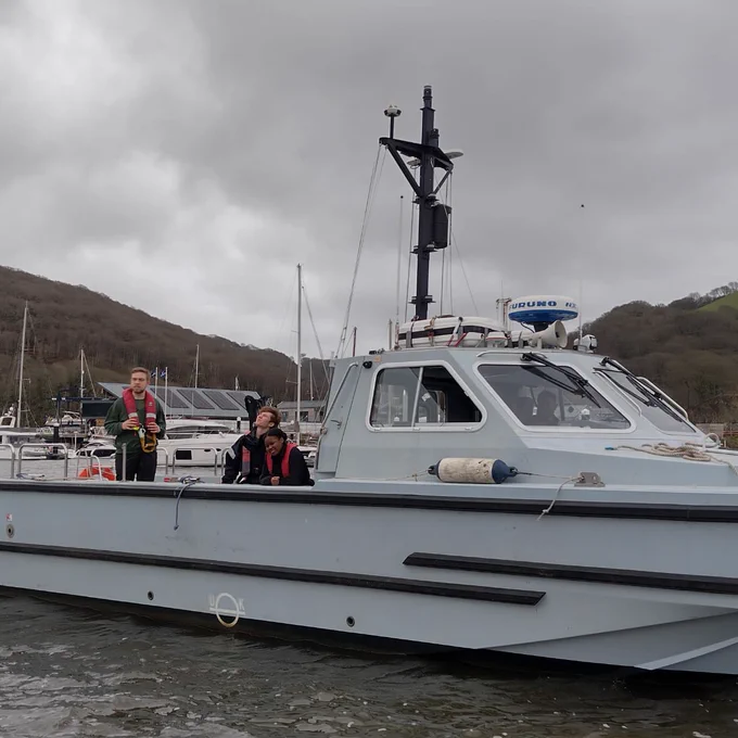 Three Officer Cadets onboard a small naval vessel