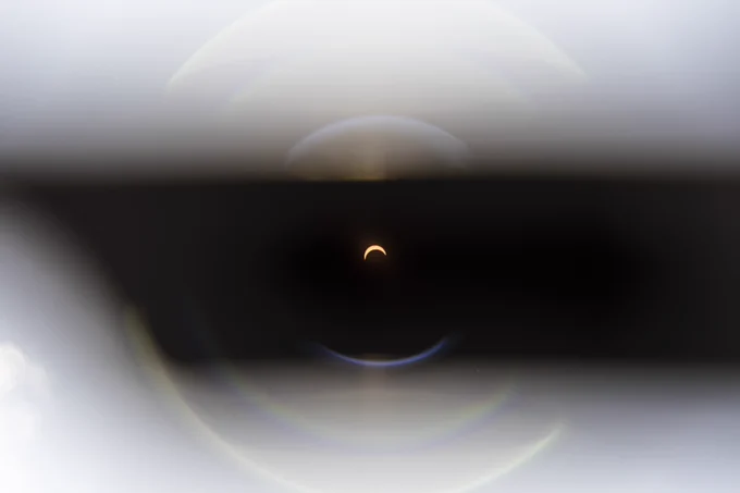 Crescent sun during an eclipse, viewed through eclipse glasses 