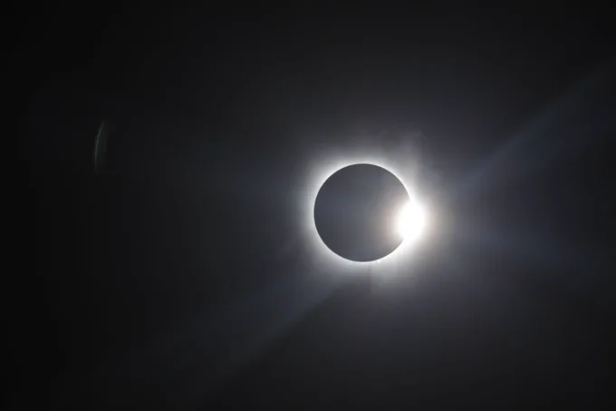 The moon passes in front of the sun over Globe Life Field during Monday's solar eclipse. (Photo: Zack Hefley/Major League Baseball)