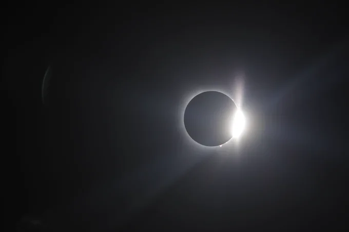 The moon passes in front of the sun over Globe Life Field during Monday's solar eclipse. (Photo: Zack Hefley/Major League Baseball)