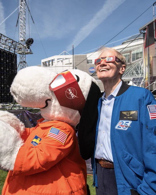 Snoopy and Administrator Bill Nelson look up into the sky wearing eclipse glasses at the Great Lakes Science Center.

Image credit: NASA/Sara Lowthian-Hanna