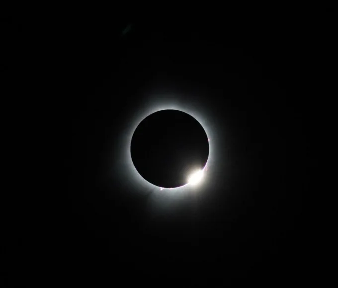 At the end of totality a piece of the Sun's edge bursts through.