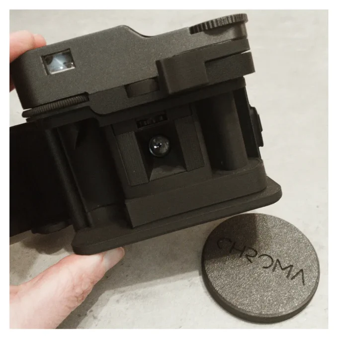 Colour photograph of the Chroma Click camera with its back open, revealing the half frame mask.