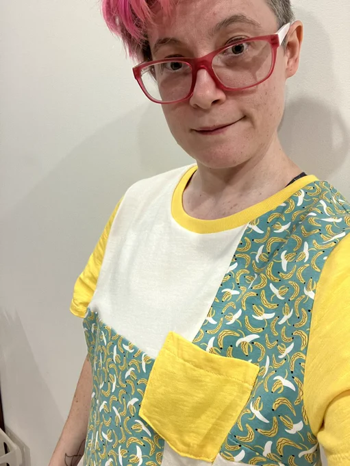 A photo of me wearing a t-shirt with white and a banana patterns on it as well as yellow sleeves and trim