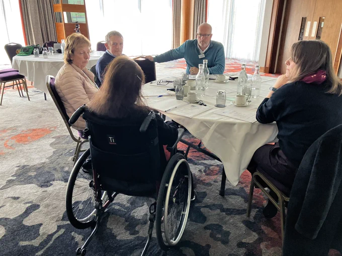 Group photo of people sitting around table