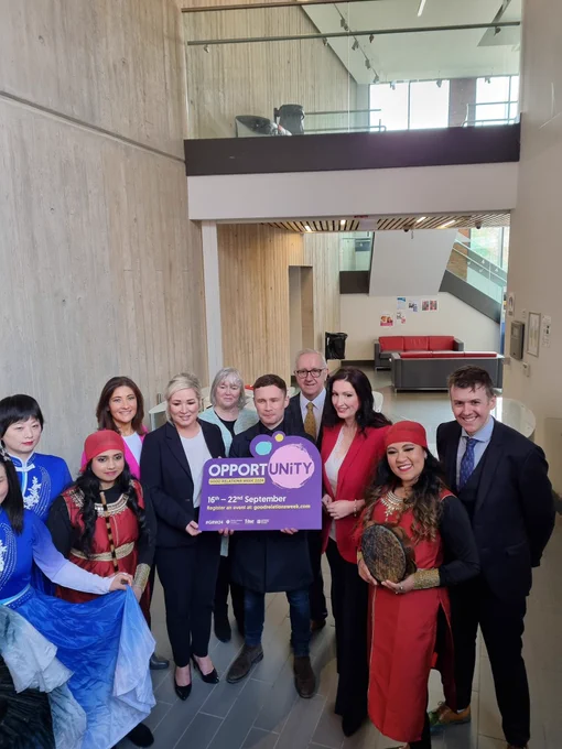 Group picture at the launch of Good Relations Week 2024. The theme is opportunity. First and deputy First Ministers are joined by Chair and CEO of CRC and boxer Carl Frampton.