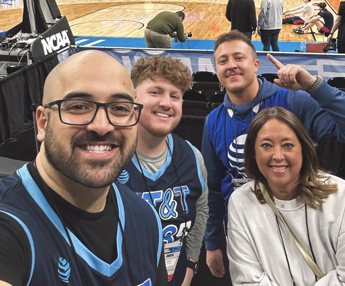 Team members in AT&T basketball jersies at a basketball game