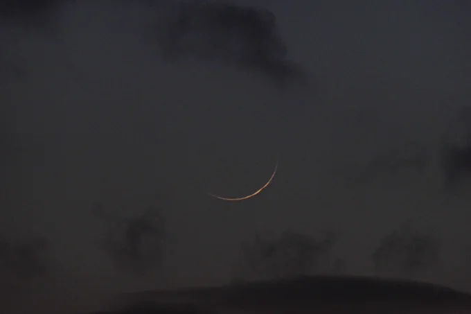 Photo of a thin crescent moon