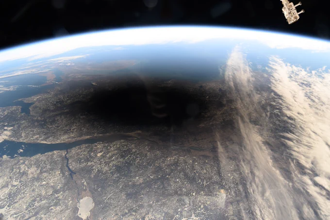 The Moon's shadow, or umbra, is pictured covering portions of the Canada and and the U.S. as the space station soared into the solar eclipse from 261 miles above.