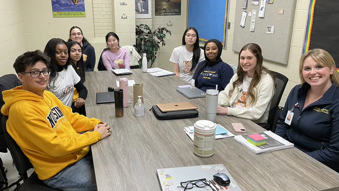 BScN students Tony Cristofanilli, Chesca Obodoechina, Poonam Sharma, Danielle LeBlanc, Sophia Hong, Kary Duong, Haifa Nuru, Olivia Rizzo and UWindsor sessional instructor Nicole Nantais review the session's plan.

