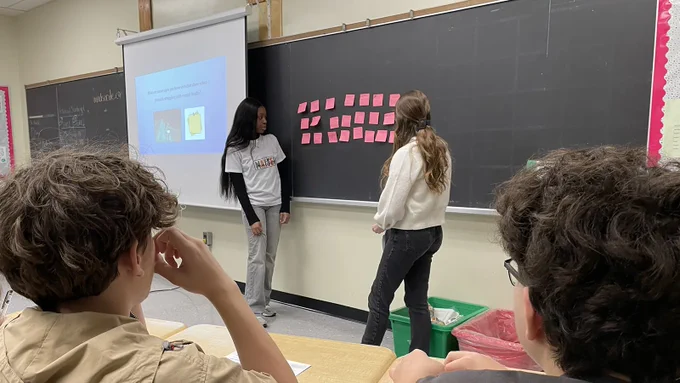 Nursing students reviewing notes on chalkboard