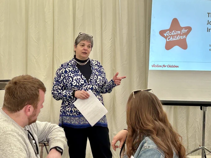 Image shows Koulla addressing the audience.