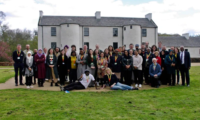 Delegates from the #Legacy150 conference. Large group photo outside in front of the fountain at the David Livingstone Centre in Blantyre with the Museum in the background. Colour photo
