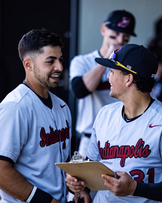 Luis Vergara (left) tells a joke to Emmanuel Rodriguez (right), causing them both to share a smile and a chuckle.