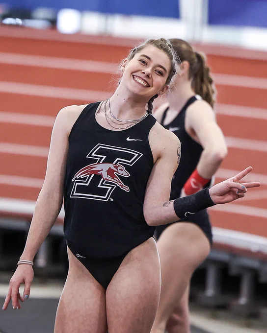 Sabrina Robison gives deuces, the victory sign, the peace sign, whatever you want to call it with a huge smile before competing at GLVC indoors.