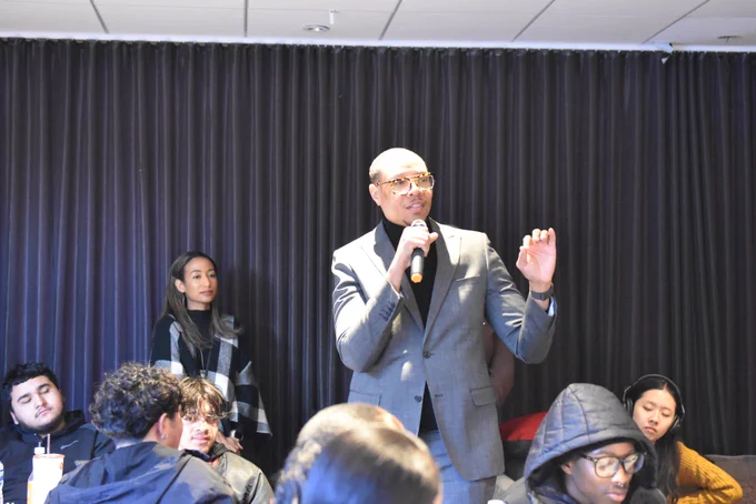 Chancellor Ferebee speaks to students while holding a microphone.