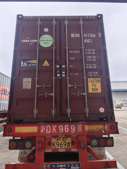 Exterior of a red shipping container on a truck.