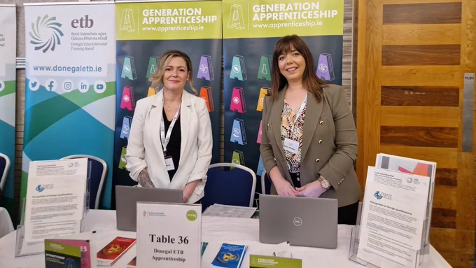 Two people at an information stand.